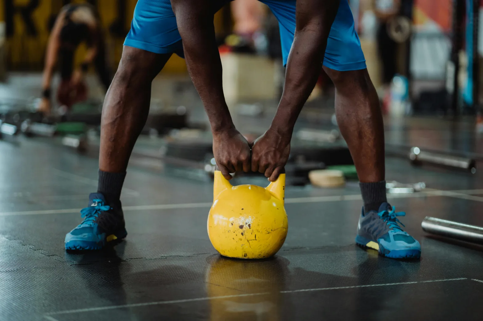 Man lifting a kettle bell at a fitness studio.