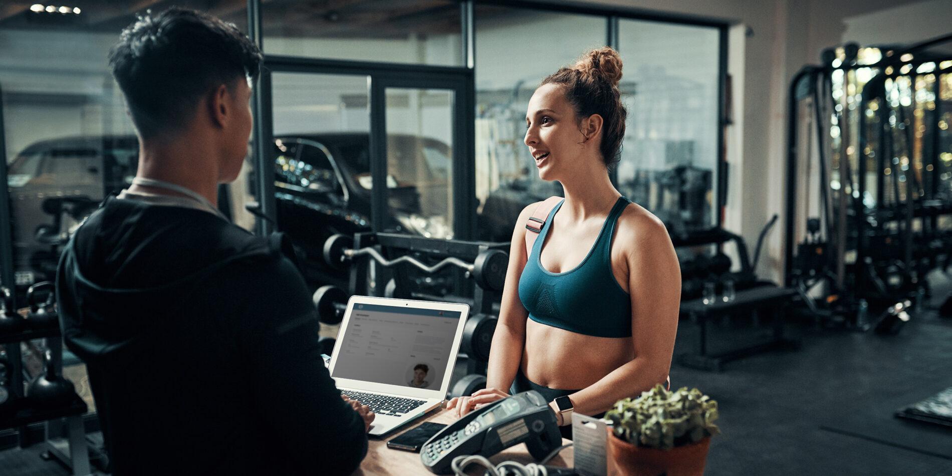 Id like to sign up for premium membership please. Cropped shot of an attractive young sportswoman talking to a male fitness instructor at the reception of a gym.